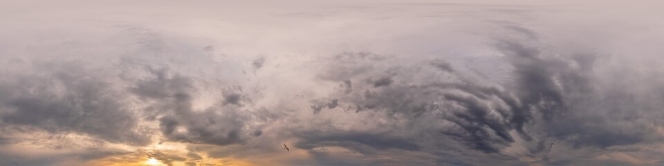 Overcast sky panorama on sunset with Cumulus clouds in Seamless spherical equirectangular format as full zenith for use in 3D graphics, game and aerial drone 360 degree panoramas for sky replacement.