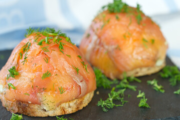 homemade healthy breakfast. toast, poached egg and salmon with herbs. Delicious and healthy food