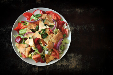 Fattoush salad on plates. Middle Eastern cuisine. Famous Arabic salad with pita bread.