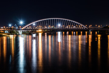Fototapeta na wymiar Nightscape of Apollo Bridge in Bratislava a road bridge over the Danube in the capital of Slovakia.