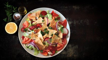 Fattoush salad on plates. Middle Eastern cuisine. Famous Arabic salad with pita bread.