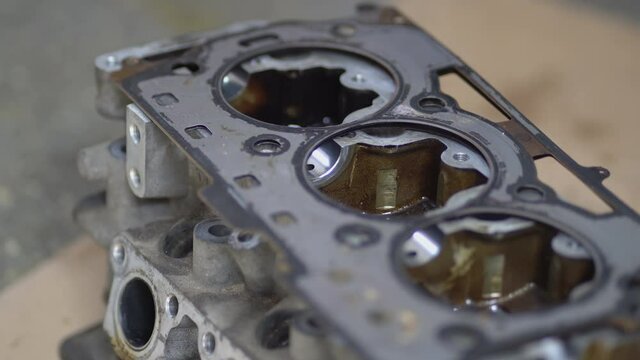 Disassembled motor engine of a car on a repair at the mechanic.The cylinder block of the four-cylinder engine. Closeup