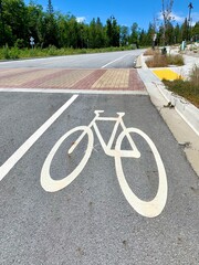 bicycle lane sign approaching speed bump on road