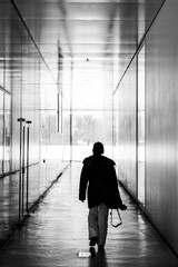 Images of loneliness, lonely person walks down a corridor