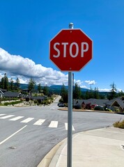 Brand new stop sign on beautiful road and blue sky