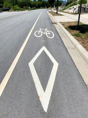 bicycle lane sign and symbol on road, white marks on asphalt surface