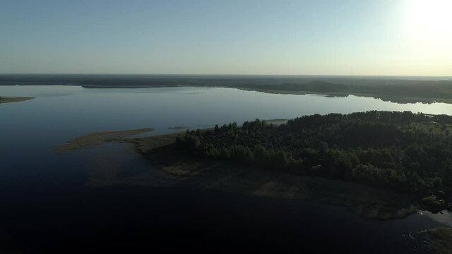 Aerial view Seliger lake in Ostashkovsky District of Tver Oblast Russia near Novgorod Oblast and Valdai Hills part of Volga basin. Summer sunny day. Dawn on beautiful Lake Seliger. Recreation and tour