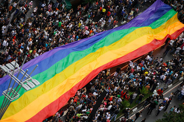 Revelers hold up a giant rainbow flag as they take part in the annual Gay Pride Parade in Paulista...