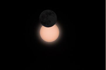 composed illustration of partial solar eclipse at maximum with dark moon in front on 10th of June 2021 near Trier, Germany