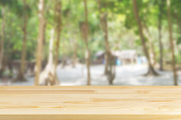 wood table top on blur beach and palm trees background