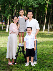 Fototapeta premium Happy family of four playing in the park