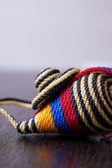 Close up of a Little striped colombian craft with the Colombia flag on a black wooden table 