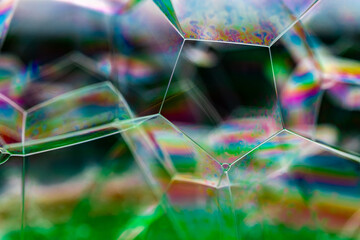 Fototapeta na wymiar Vivid rainbow colours of a Macro soap bubbles creating psychedelic patterns under light dome