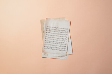 Naklejka premium close up ancient old paper sheet with music notes, classic culture arts