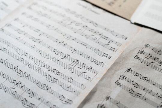 close up ancient old paper sheet with music notes, classic culture arts