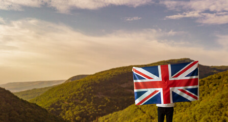 male person with a UK national flag, patriotism and freedom concept outdoors