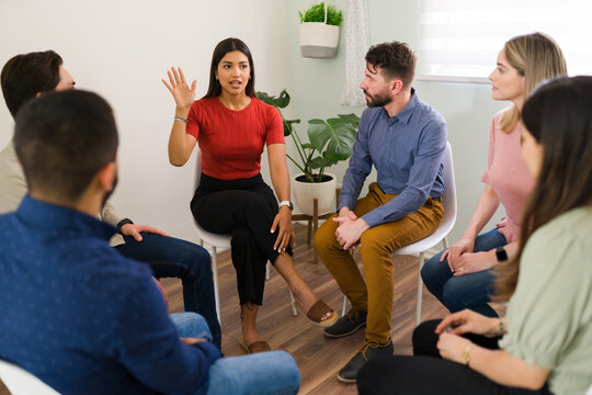 Hispanic woman is introducing herself at group therapy
