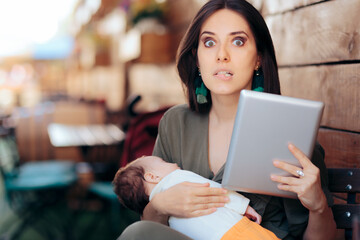 Busy Mom Trying to Work Remotely While Holding Sleeping Baby