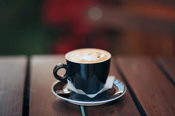Coffee Cup on a Plate Siting on a Restaurant Table