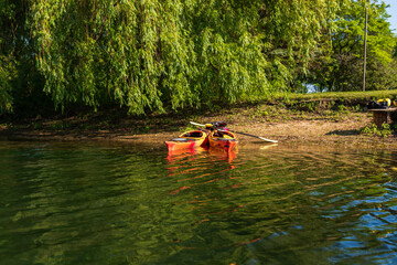 Two sea kayaking parked on a tiny beach on the Toronto Islands on a sunny June afternoon.