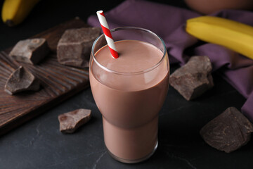 Fresh yummy chocolate milk on black table