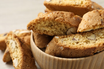 Traditional Italian almond biscuits (Cantucci) in bowl on table, closeup