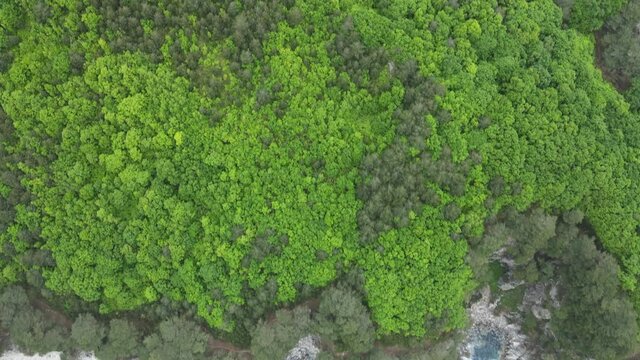 View from above. Far Eastern Marine Reserve. The camera zooms in on a small rocky island washed by the Pacific Ocean. A picturesque uninhabited island in the sea.
