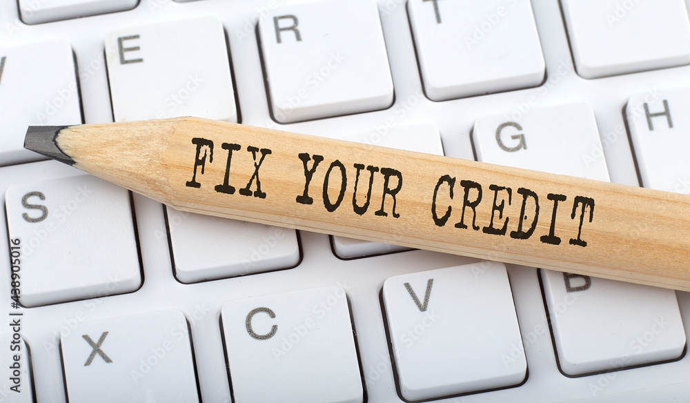 Poster fix your credit text on pencil on the keyboard on background