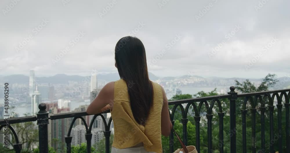 Wall mural woman enjoy hong kong city view at the peak