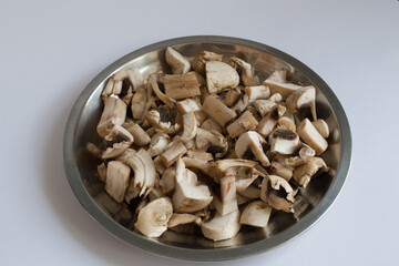 Common edible mushrooms in steel plate in isolated white background
