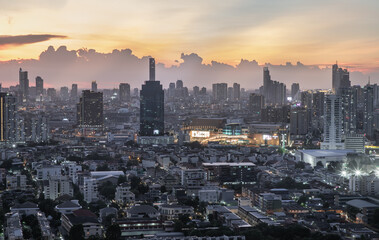 Fototapeta premium Bangkok, Thailand - Jun 01, 2021: Aerial view of Beautiful scenery view of Skyscraper Evening time Sunset creates relaxing feeling for the rest of the day. Selective focus.