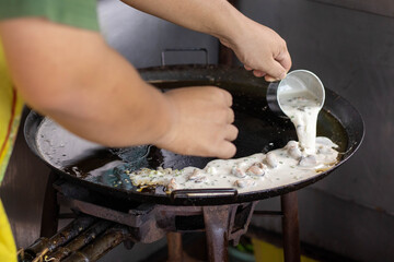 man grilling meat on barbecue