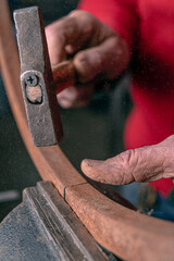 carpenter cutting wood with saw