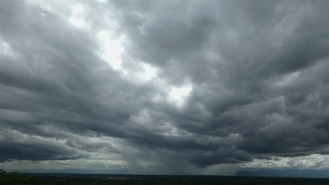 Time-lapse of The dark expanse of the sky, a huge and, foretelling the arrival of a big, stormy rain and thunderstorm. This atmospheric display adds a dramatic touch to the natural environment.