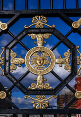 A fragment of an iron fence near the Kremlin Wall with gilded patterns in Moscow, Russia