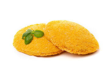 Chicken nuggets or yellow cutlets decorated with basil leaf, isolated on a white background.