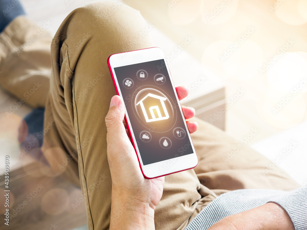 Aufkleber man using mobile phone and smart home application as automation assistant. futuristic smart technolo