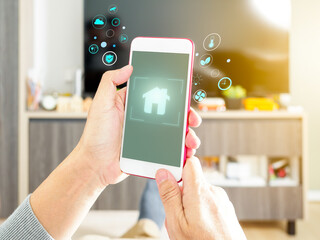 Man using mobile phone and smart home application as automation assistant. Futuristic smart technology Concept
