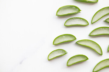 Natural green aloe vera stem cut into slices. Health and well being background