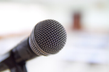 Fototapeta premium Hands holding a microphone in a conference room. 