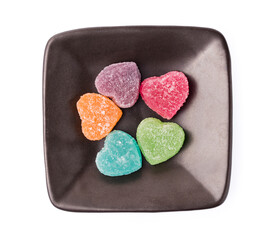 Colorful heart shape jellys on plate isolated on white background