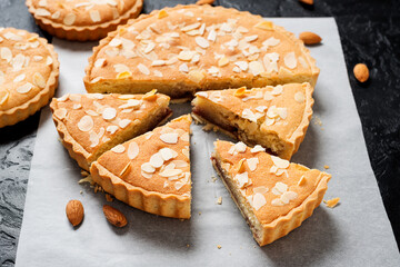 Strawberry Almond Bakewell Tart. Traditional British cuisine. Dark background.	