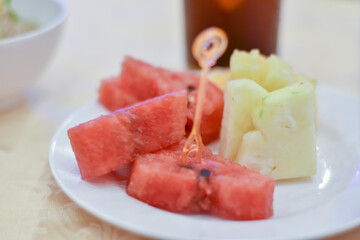 Watermelon turned into pieces on a white plate.