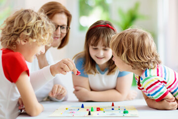 Family playing board game. Kids play.