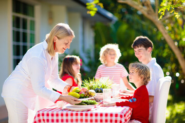 Family eating outdoor. Garden summer fun.
