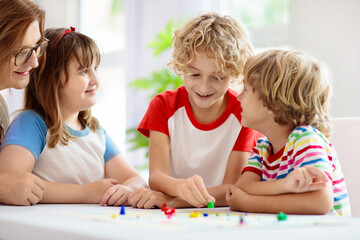 Fototapeta premium Family playing board game. Kids play.
