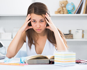 Student girl is solving an equation at home.