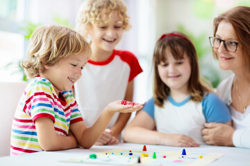 Family playing board game. Kids play.