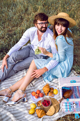 Elegant couple making tasty picnic outdoor