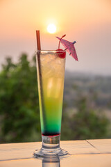 Cocktail near the swimming pool at sunset
